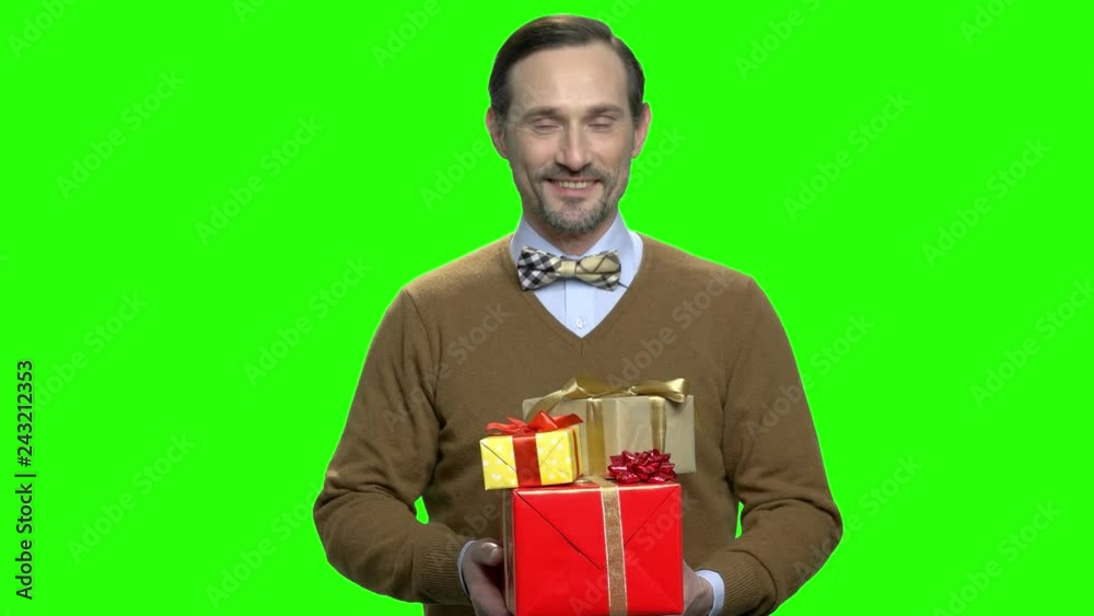 Husband giving presents gifts for christmas. Handsome caucasian man portrait. Green screen hromakey background for keying. Husband giving presents gifts for christmas. Handsome caucasian man portrait. Green screen hromakey background for keying.