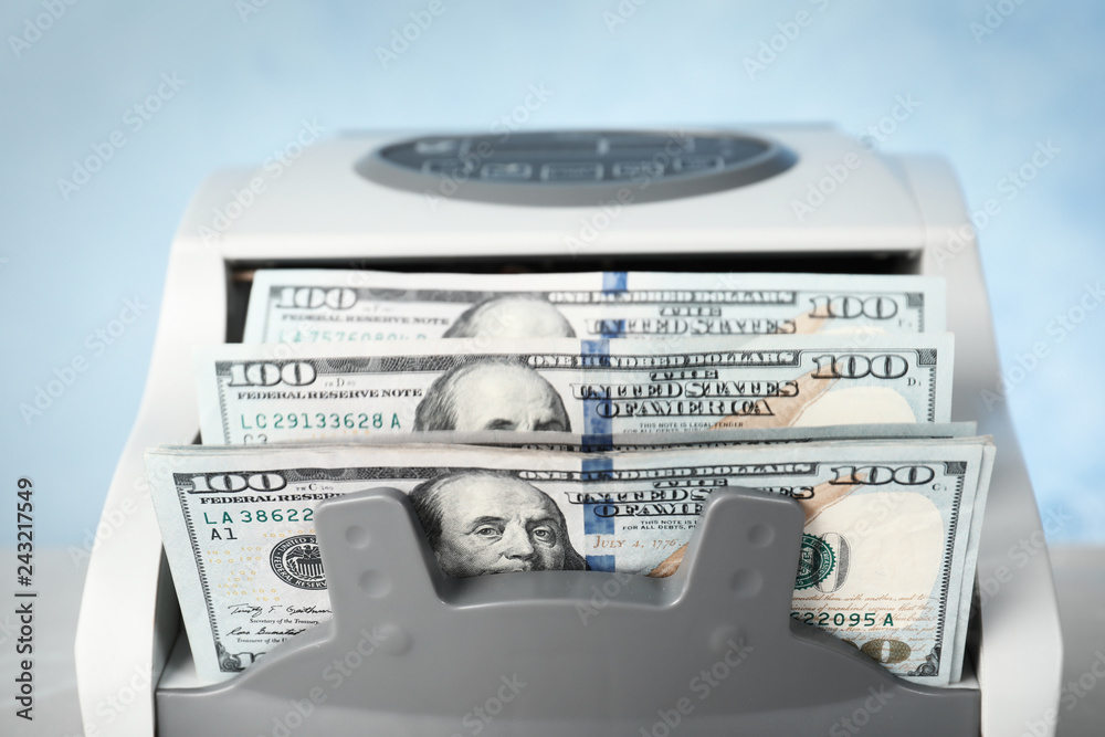 Modern bill counter with money, closeup view