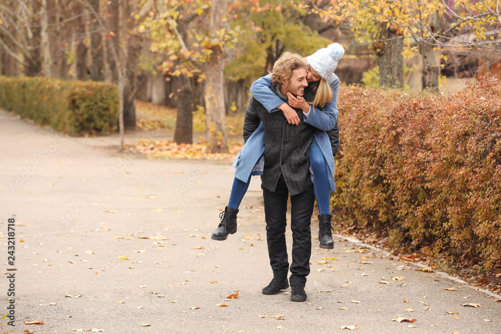 Young romantic couple having fun in park on autumn day Young romantic couple having fun in park on autumn day