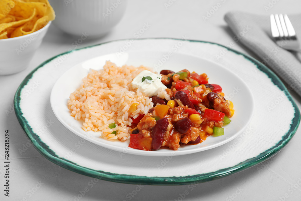 Chili con carne served with rice and sauce on table Chili con carne served with rice and sauce on table