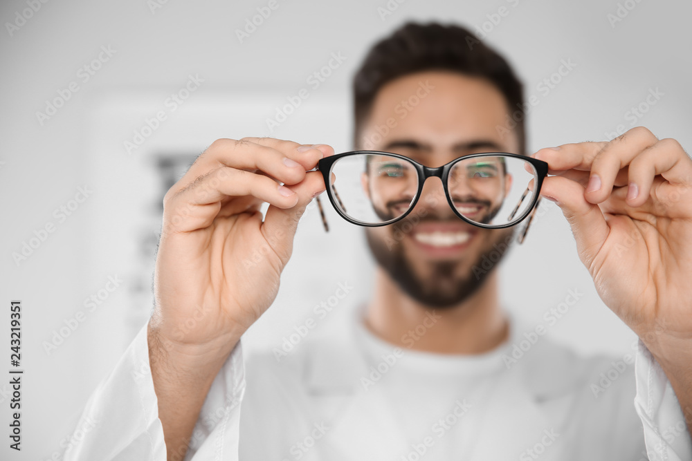 Fototapeta premium Male ophthalmologist with eyeglasses in clinic, closeup