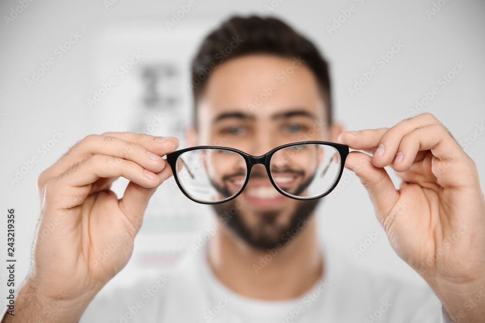 Fototapeta premium Male ophthalmologist with eyeglasses in clinic, closeup