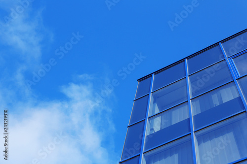 Modern office building with tinted windows against blue sky