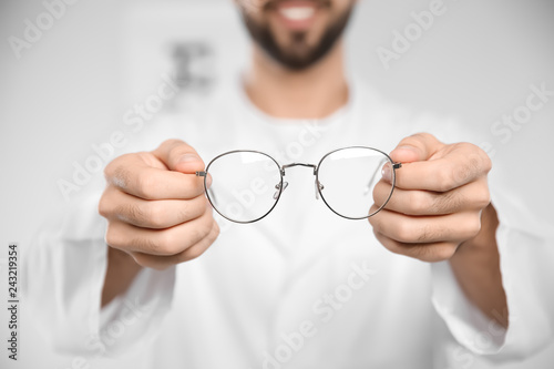 Male ophthalmologist with eyeglasses in clinic, closeup