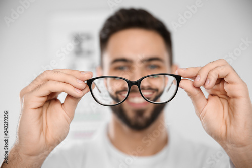 Male ophthalmologist with eyeglasses in clinic, closeup