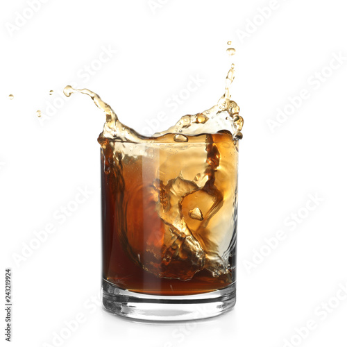 Glass of expensive whiskey with splash on white background