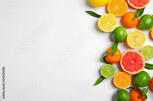 Different citrus fruits on white background  top view. Space for text