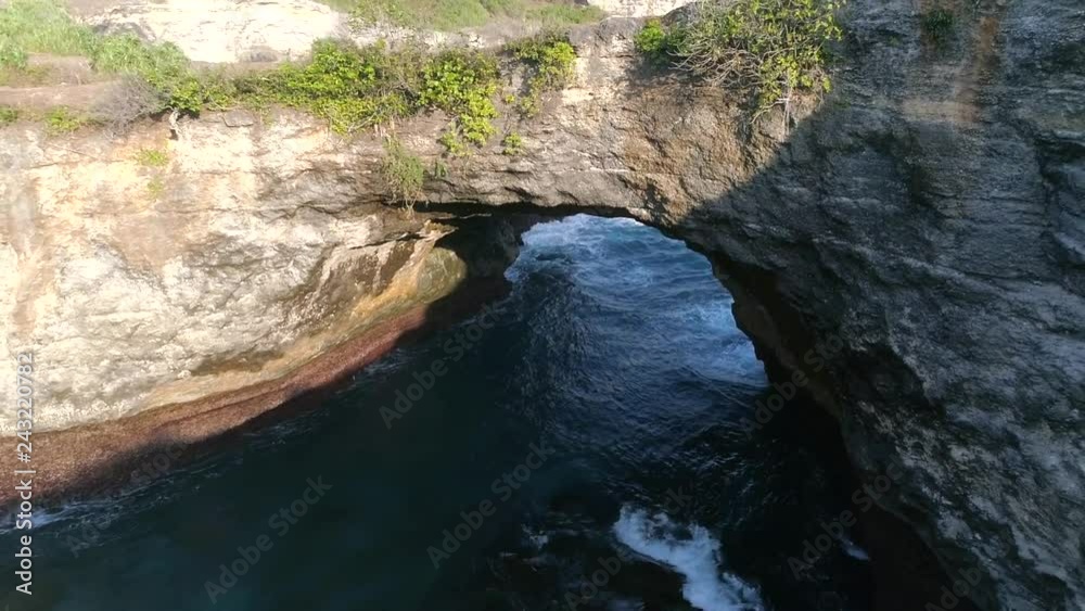 Aerial view of arch formation in the coast of Bali island, Indonesia. Aerial view of arch formation in the coast of Bali island, Indonesia.