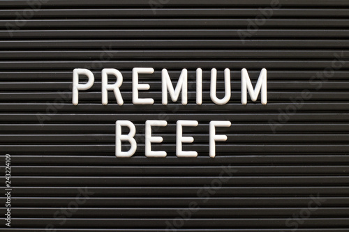 Black color felt letter board with white alphabet in word premium beef background