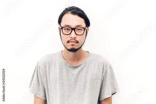 Portrait of a asian young handsome man while standing isiolated on white background