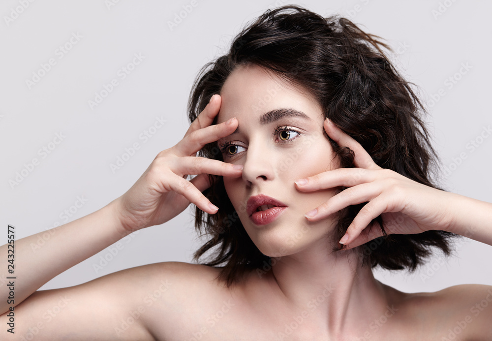 Obraz premium Closeup beauty portrait of young woman with hands near face