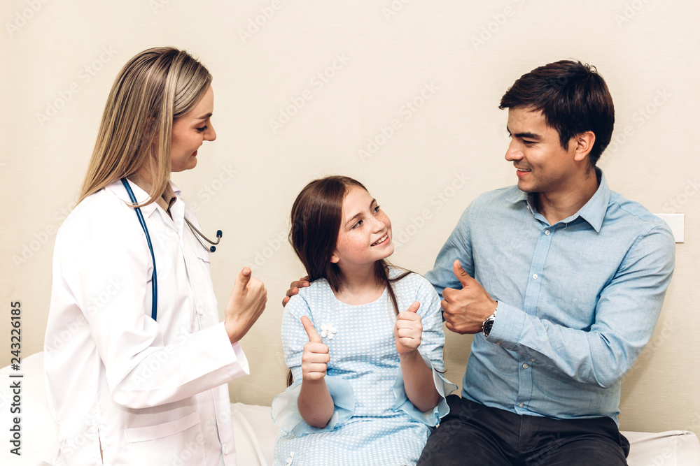 Doctor looking at camera while young family father and little girl on background together Doctor looking at camera while young family father and little girl on background together