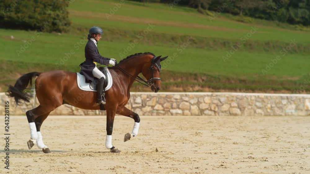 SUPER SLOW MOTION English rider on horseback riding trot around the