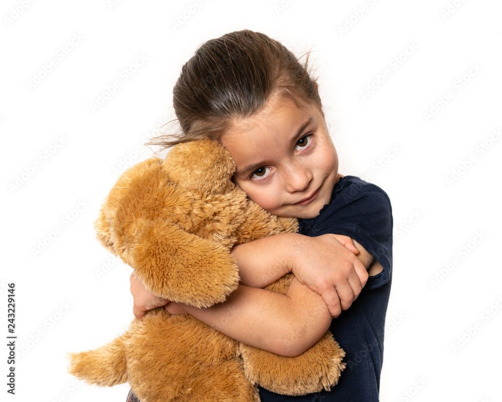 Happy preschool girl cuddling her favorite teddy bear Happy preschool girl cuddling her favorite teddy bear