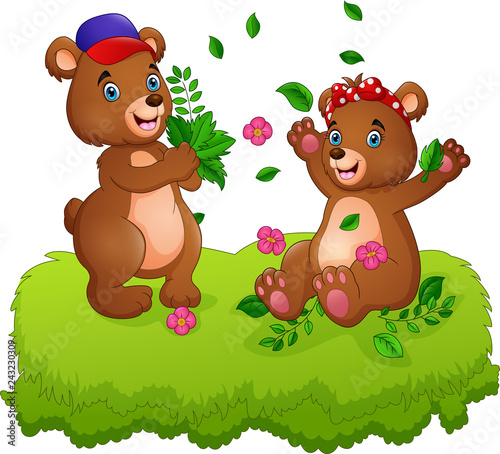 Cute couple of teddy bears playing with fallen leaves