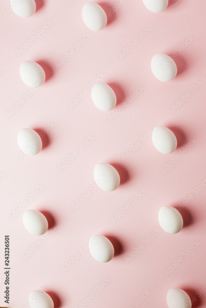 White eggs on a light pink background with reflection of the shadows and copy space. layout to easter. Flat lay, pattern White eggs on a light pink background with reflection of the shadows and copy space. layout to easter. Flat lay, pattern