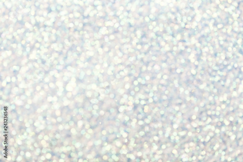 Blurred shiny white background with sparkling lights.