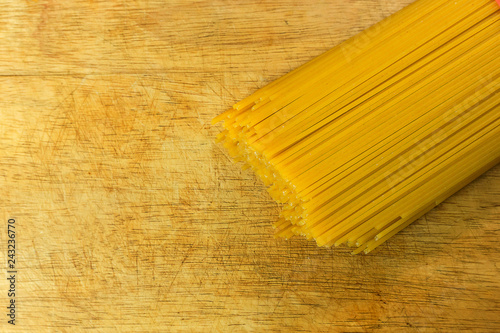 Spaghetti raw in white on wood table