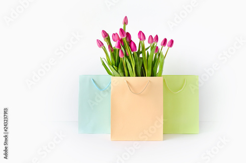 Fresh bright bouquet of pink tulip in paper bags. Beautiful greeting card. Spring holidas concept. photo