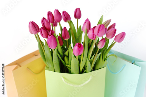 Fresh bright bouquet of pink tulip in paper bags. Beautiful greeting card. Spring holidas concept. photo