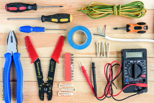 Electrical equipment and tools on wooden table with copy space.