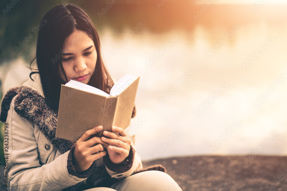 Fototapeta premium Women in winter sit read favorite book in the holiday, Concept girl reading a book.