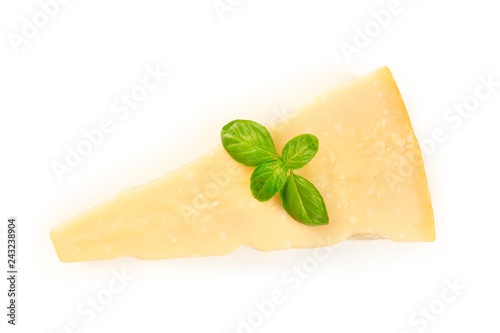фотографія A piece of aged Parmesan cheese with fresh basil leaves, shot from the top on a