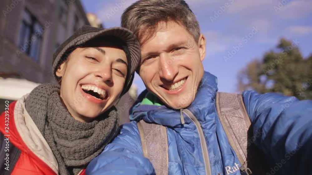 romantic enamoured couple hugging and making selfie during the city walk. Two lovers Enjoying spending time together at the warm autumn or spring day. romantic enamoured couple hugging and making selfie during the city walk. Two lovers Enjoying spending time together at the warm autumn or spring day.