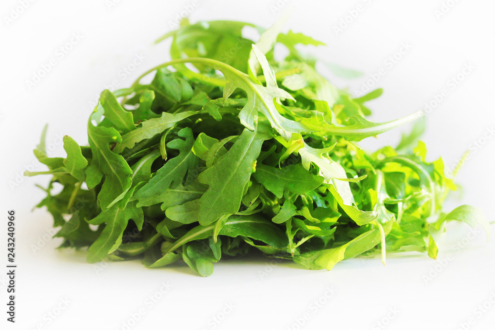 Fresh arugula leaves rucola on white background Fresh arugula leaves rucola on white background