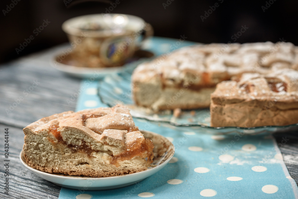 Homemade apple pie with cup of coffee on grey wooden table. Homemade apple pie with cup of coffee on grey wooden table.