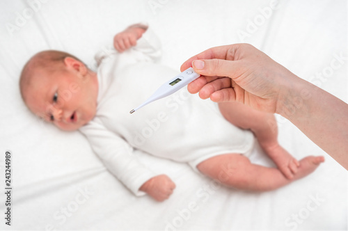 Measuring temperature to a newborn baby with digital thermometer