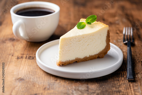 Cheesecake and cup of coffee on wooden table. Coffee and cake. Horizontal view