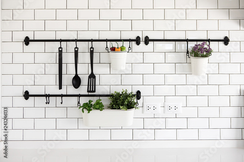 Photography kitchen utensil hanger on white brick wall