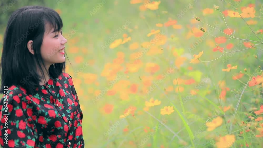 asian younger woman relaxing in flower blooming garden asian younger woman relaxing in flower blooming garden