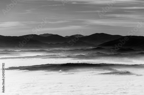 Fog filling a valley in Umbria (Italy), with layers of mountains and hills
