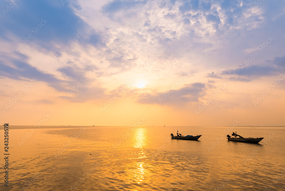 Beautiful sunrise on the beach and silhouette of fishing boat.Thailand. Beautiful sunrise on the beach and silhouette of fishing boat.Thailand.