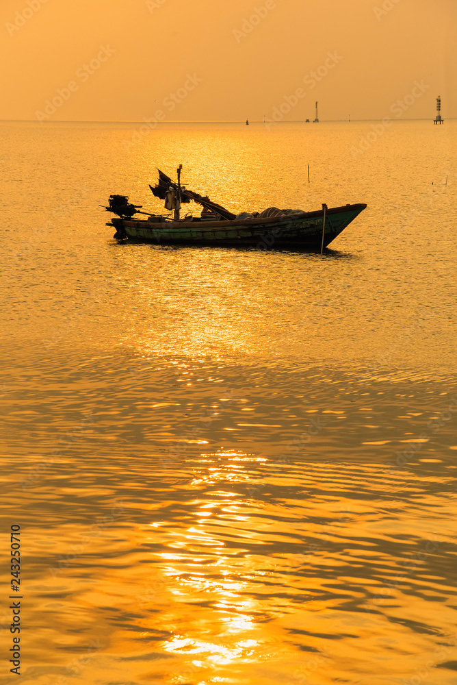 Beautiful sunrise on the beach and silhouette of fishing boat.Thailand. Beautiful sunrise on the beach and silhouette of fishing boat.Thailand.