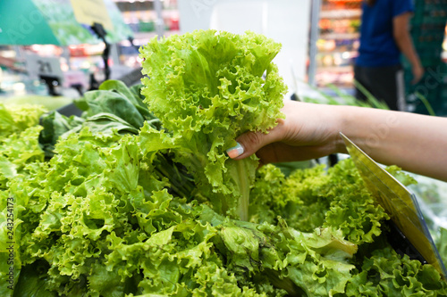 Hand of woman choosing salads at the supermarket..
