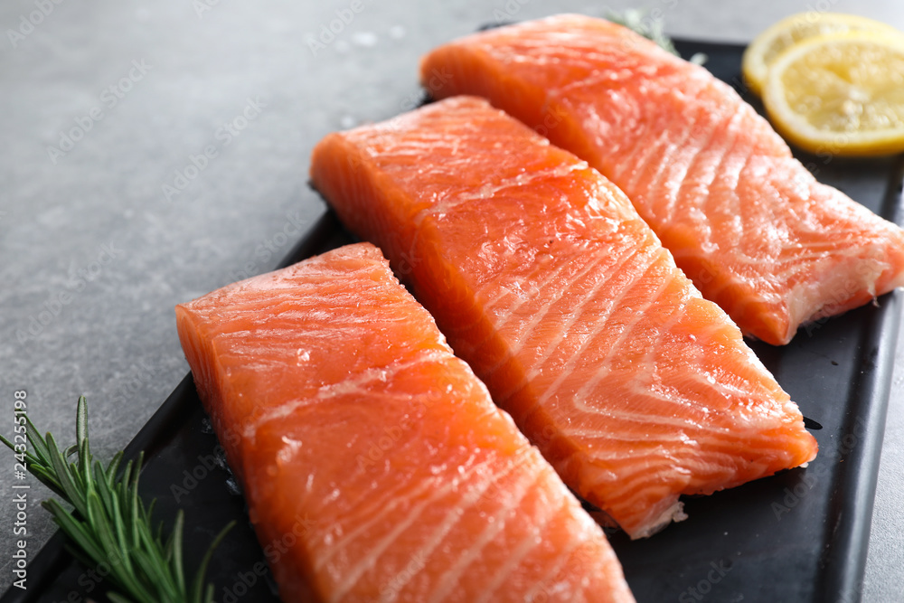 Plate with cut salmon fillet on table, closeup Plate with cut salmon fillet on table, closeup