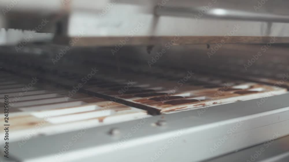 Chocolate factory, pouring chocolate candy molds, production of sweets and desserts. Chocolate factory, pouring chocolate candy molds, production of sweets and desserts.