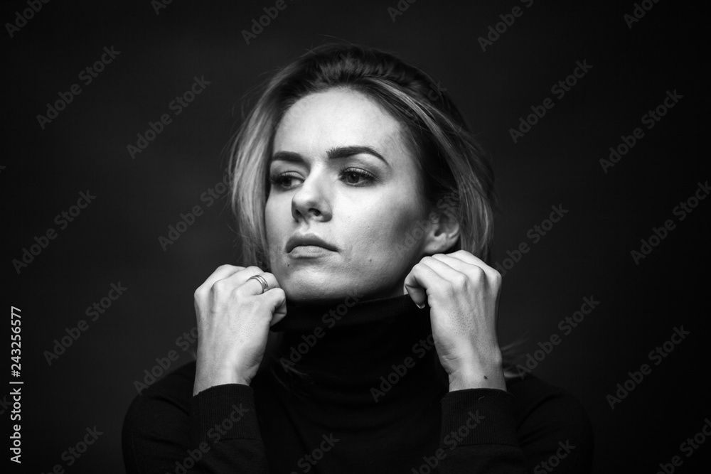 Dramatic black and white portrait of a beautiful woman on a dark background Dramatic black and white portrait of a beautiful woman on a dark background