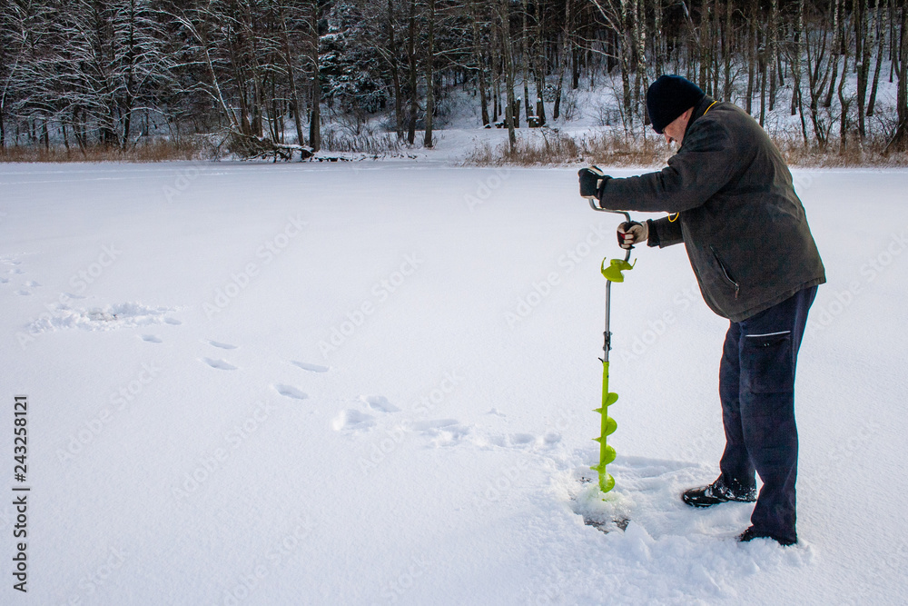 Small hand operated ice auger used in ice fishing, hand fishing