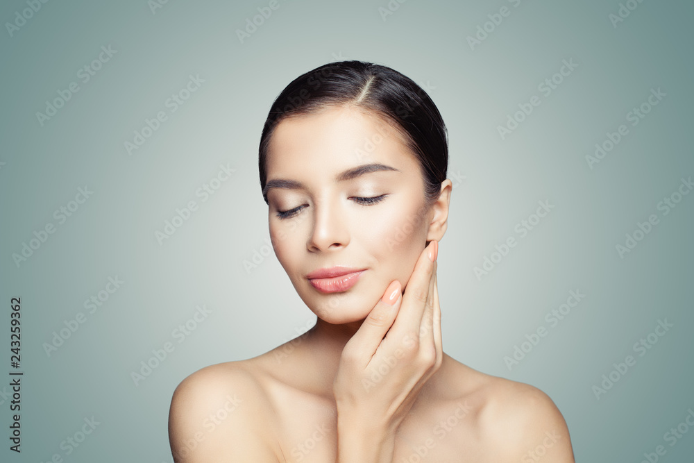 Cute female model face. Beautiful spa woman on blue background Cute female model face. Beautiful spa woman on blue background