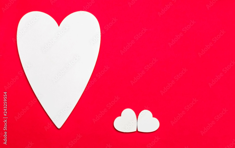 Valentine's day holiday, wedding invitation. Symbol of love white wooden heart on a red background with empty space for text Valentine's day holiday, wedding invitation. Symbol of love white wooden heart on a red background with empty space for text
