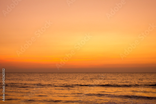 bright yellow gray pink sunset sky over the ocean © Pavel