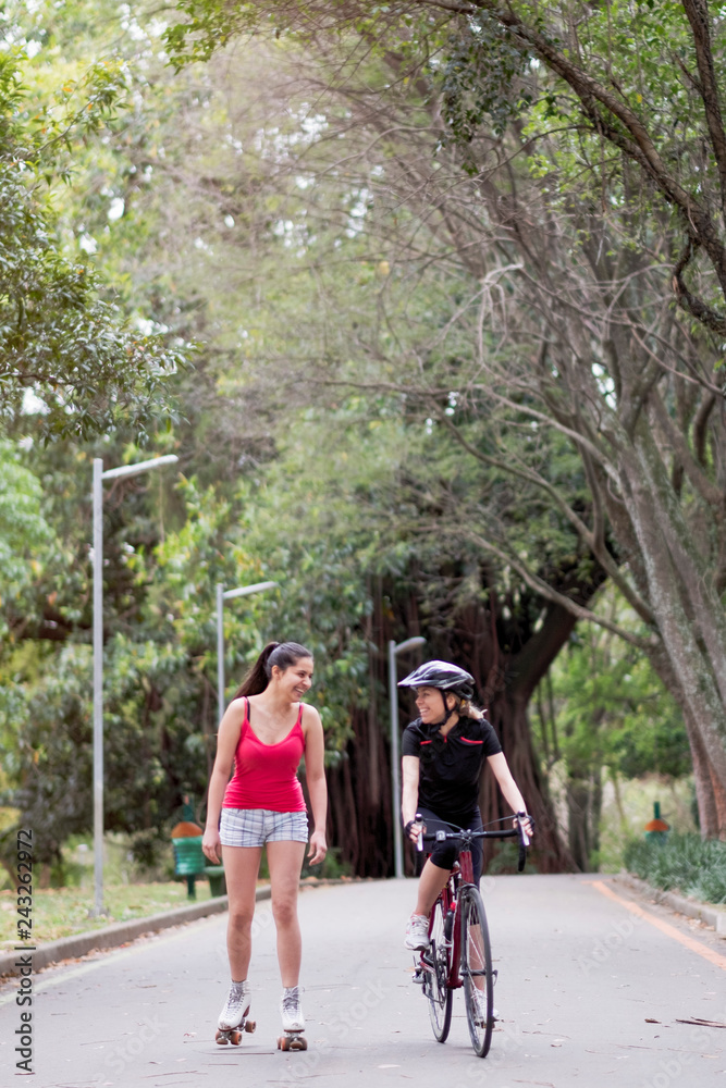 Two sporty young women talking together in Ibirapuera park