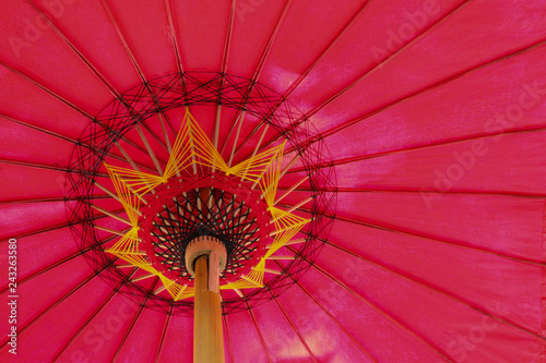 Closeup of  under side of red handmade umbrella.