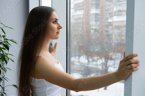 woman near window.Dream and relax