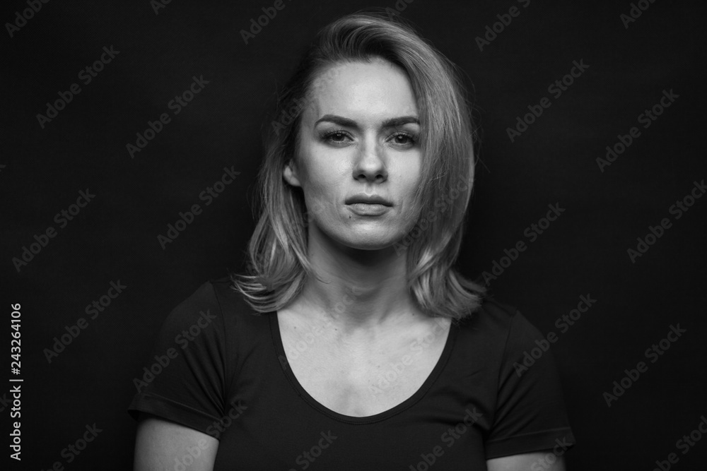 Dramatic black and white portrait of a beautiful woman on a dark background Dramatic black and white portrait of a beautiful woman on a dark background