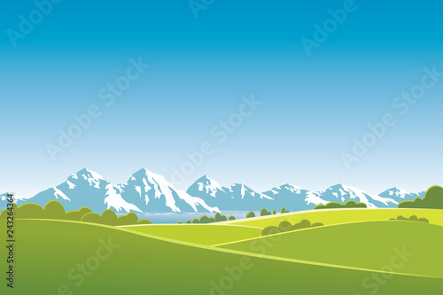 Gree landscape with mountains and blue sky